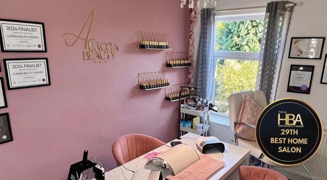 Elegant interior of Aurora Beauty Cheshire salon in Congleton, England, showcasing awards and modern decor.