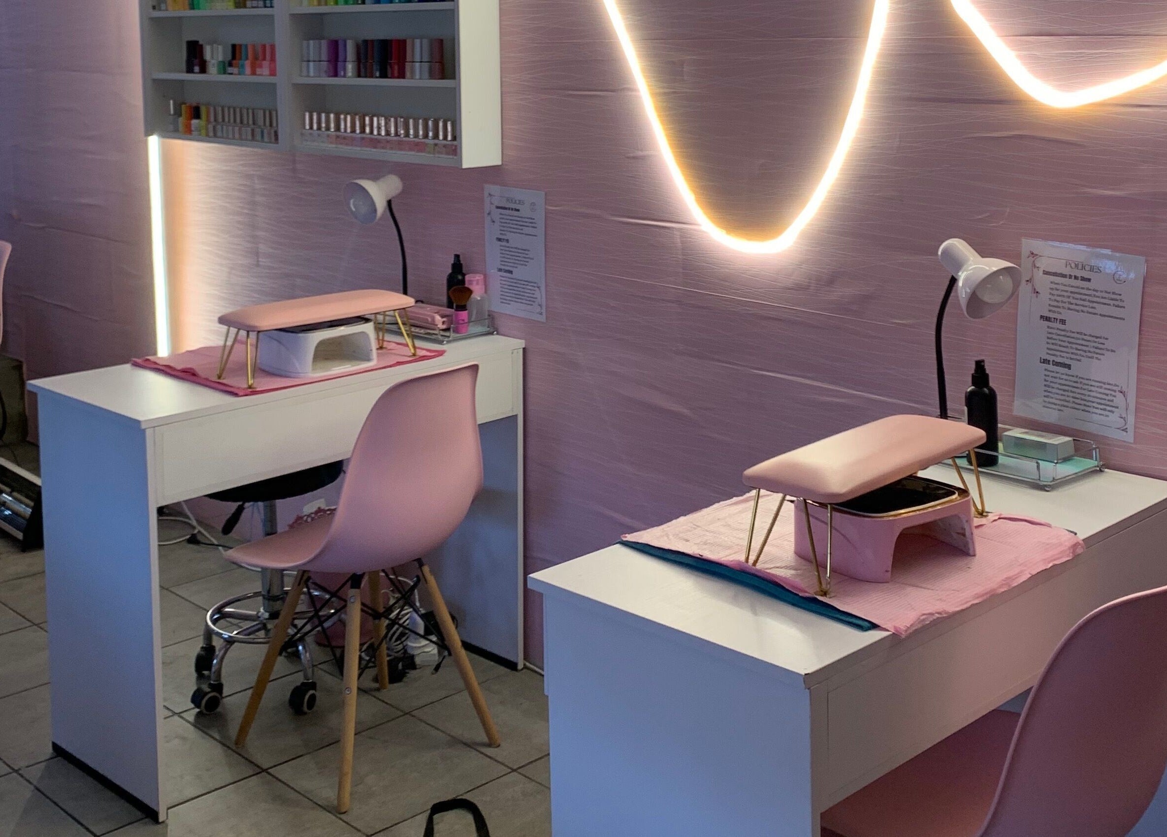 Stylish nail salon setup at Me Myself And Nails, Soweto, Gauteng, ZA with pink decor and modern lighting.
