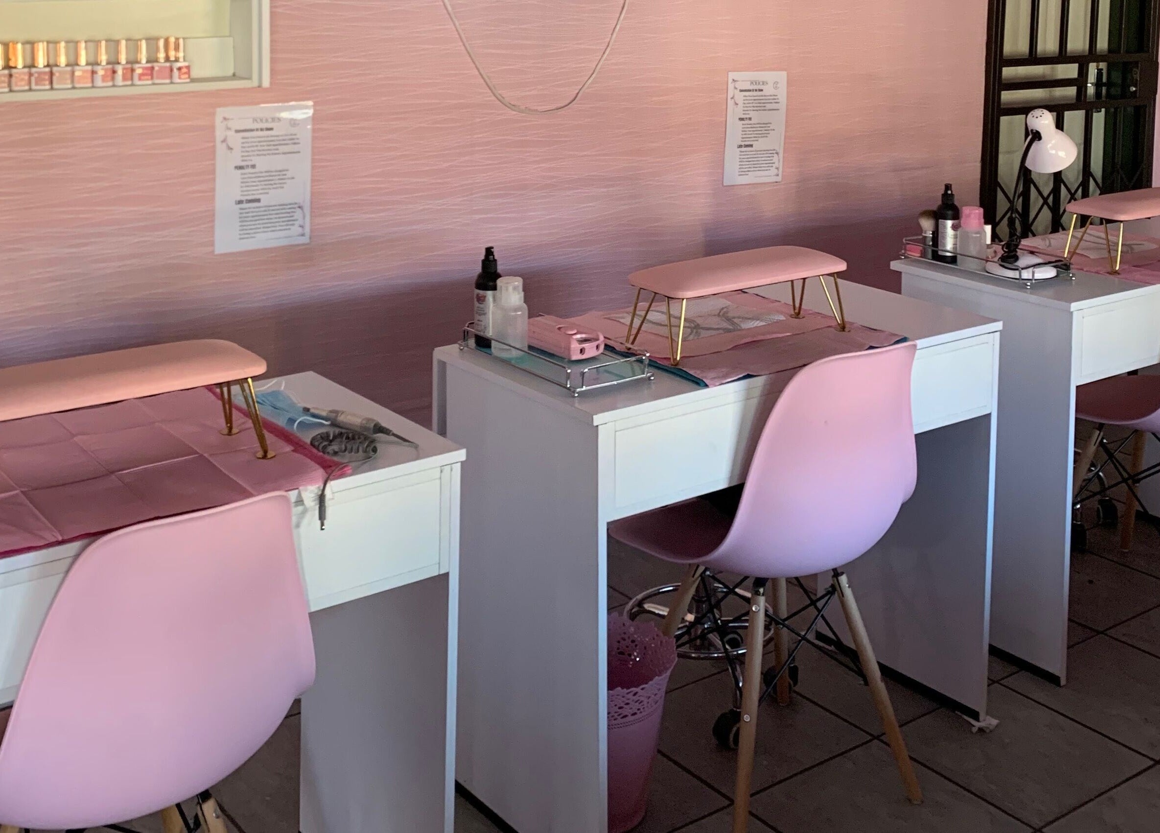 Chic nail salon setup at Me Myself And Nails in Soweto, Gauteng, ZA featuring pink decor and modern furniture.