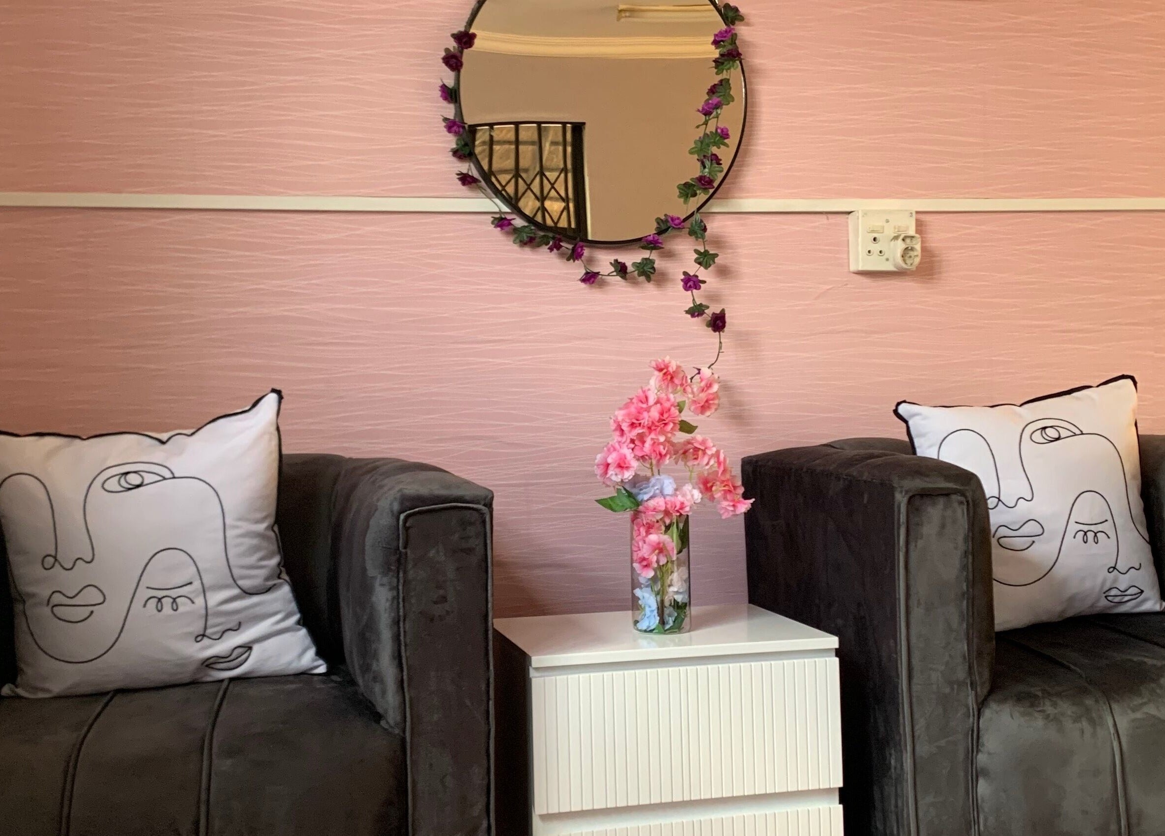 Elegant salon seating area at Me Myself And Nails in Soweto, Gauteng, ZA with pillows and floral decor.