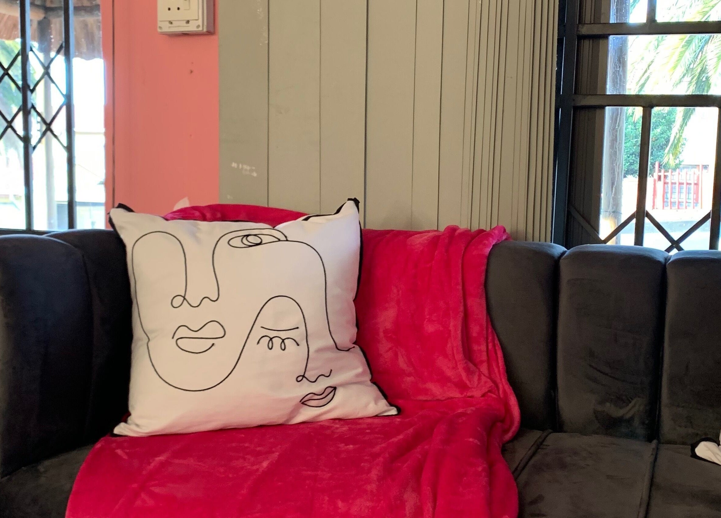 Stylish couch with abstract pillows at Me Myself And Nails, Soweto, Gauteng, ZA.