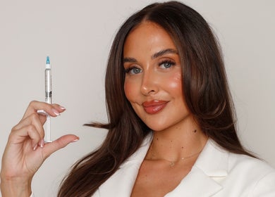 Woman holding a syringe at Skin and Co Aesthetics, Basingstoke, England, GB, showcasing skincare treatment services.