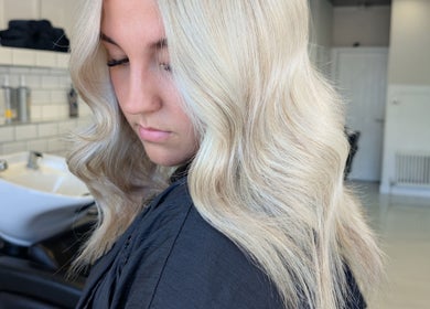 Woman with wavy blonde hair styled at Hair by Karina Brown, Leeds, England, GB.