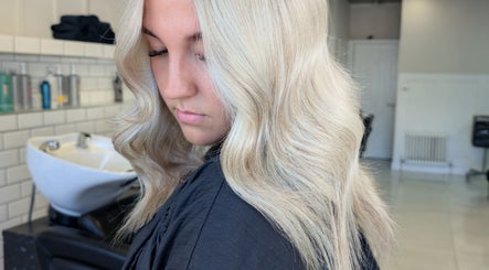 Woman with wavy blonde hair styled at Hair by Karina Brown, Leeds, England, GB.