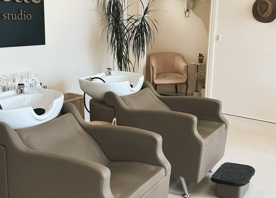 Modern wash stations at Odette Hair Studio, Prince Edward, Ontario, CA with stylish chairs and decor.