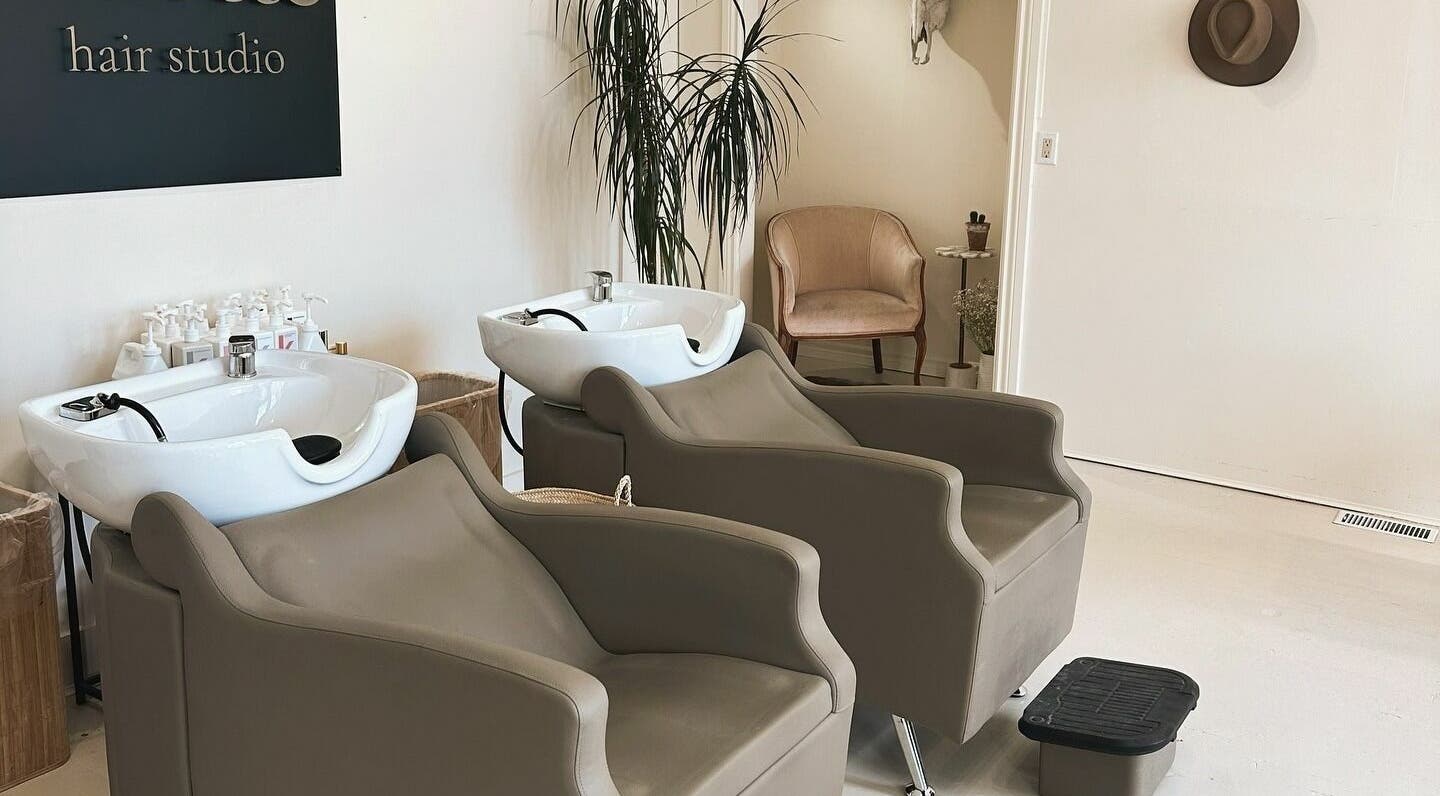 Modern wash stations at Odette Hair Studio, Prince Edward, Ontario, CA with stylish chairs and decor.