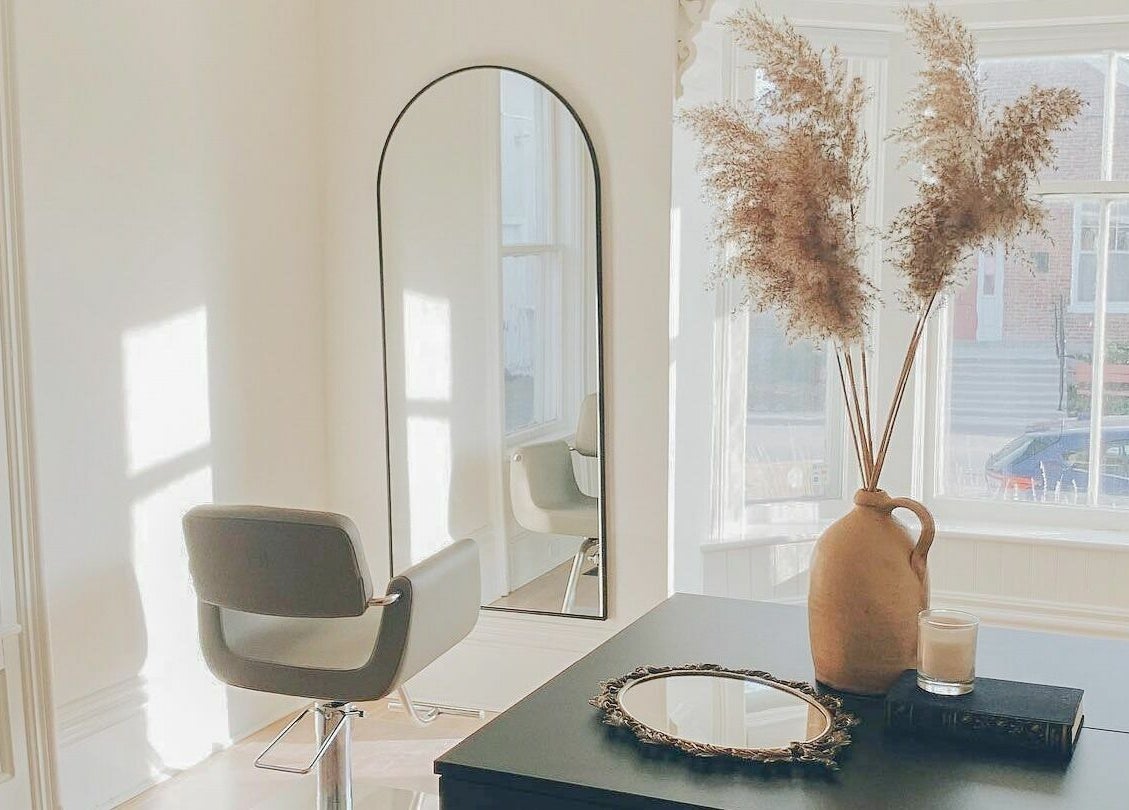 Minimalist styling station at Odette Hair Studio, Prince Edward, Ontario, CA, with earthy decor.
