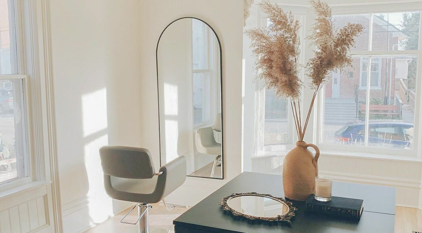 Minimalist styling station at Odette Hair Studio, Prince Edward, Ontario, CA, with earthy decor.