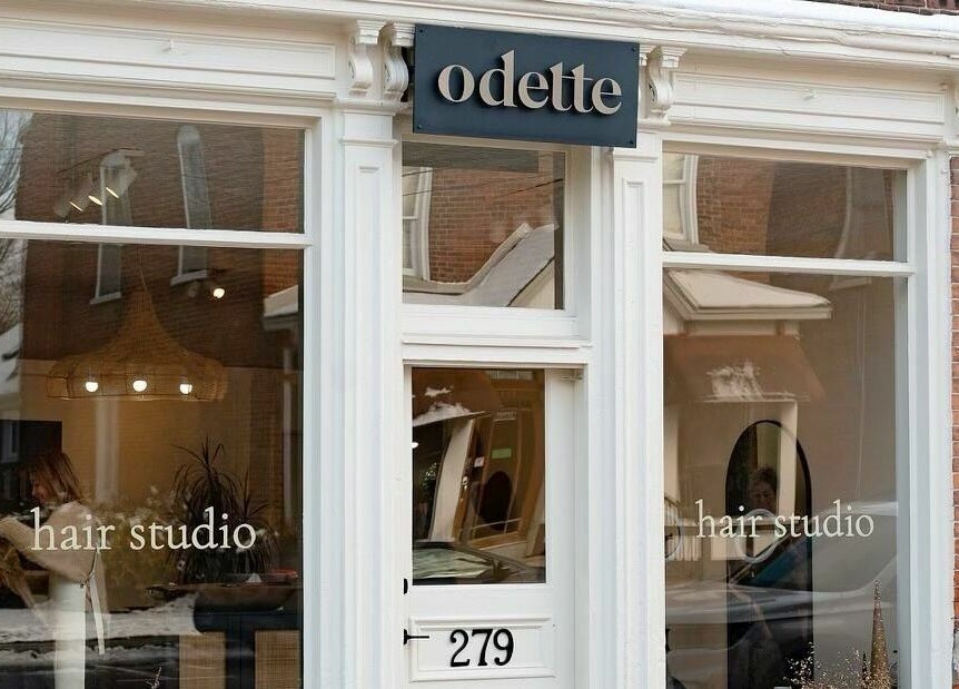 Front view of Odette Hair Studio in Prince Edward, Ontario, CA with stylish glass windows.