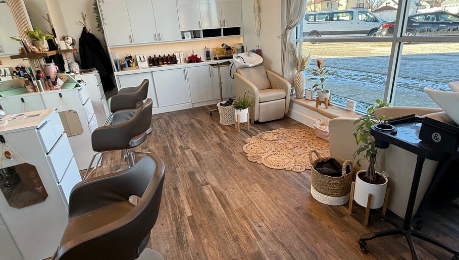 Bright, modern salon interior at Hair by Laura Pierini in Massapequa, New York, US, featuring stylish decor.