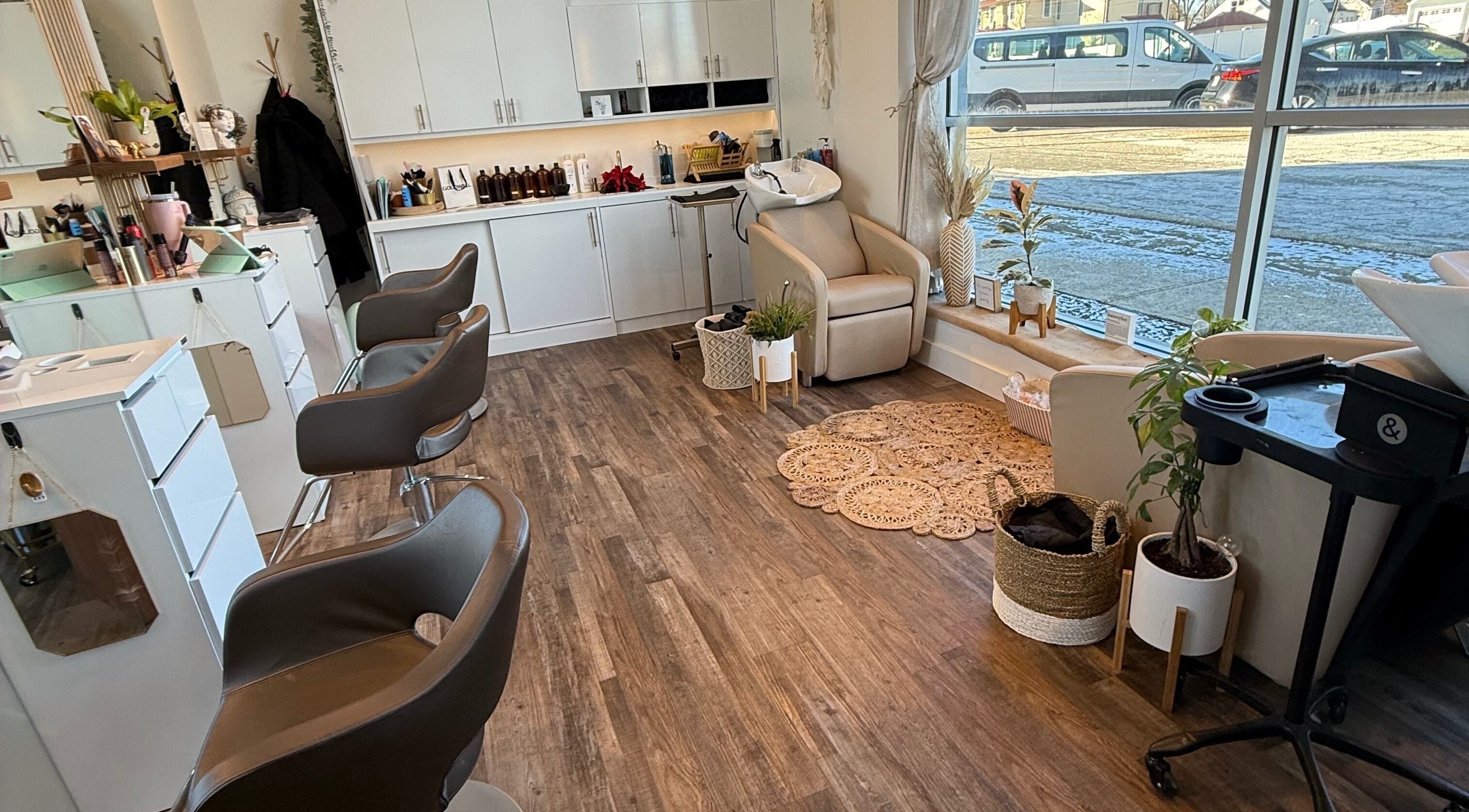 Bright, modern salon interior at Hair by Laura Pierini in Massapequa, New York, US, featuring stylish decor.