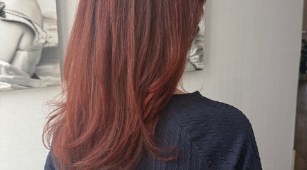 Vibrant auburn hair styled by Hair by Laura Pierini in Massapequa, New York, US, showcasing rich color and shine.