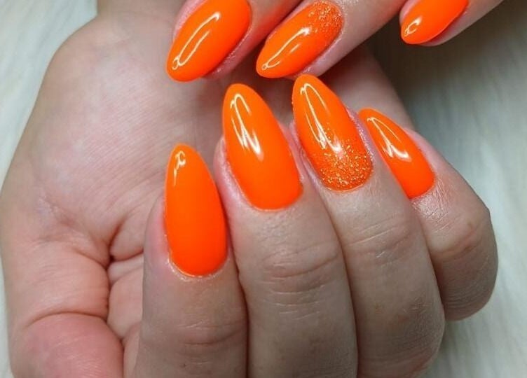 Bright orange acrylic nails from Moois Beauty Lash and Brow Bar in Johannesburg, Gauteng, ZA.