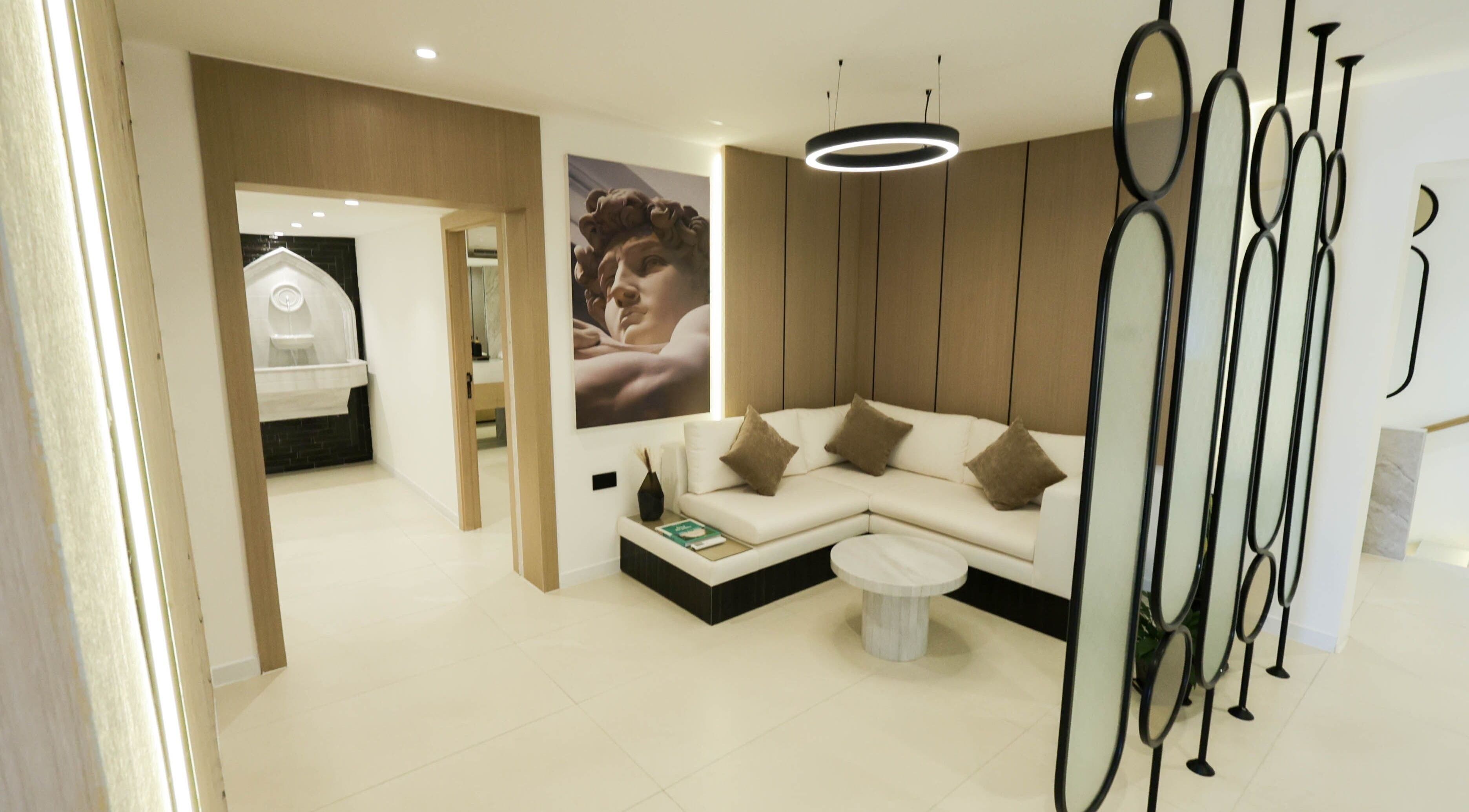 Stylish lounge area at Antibes Salon Riffa in Riffa, BH, featuring modern decor and cozy seating.