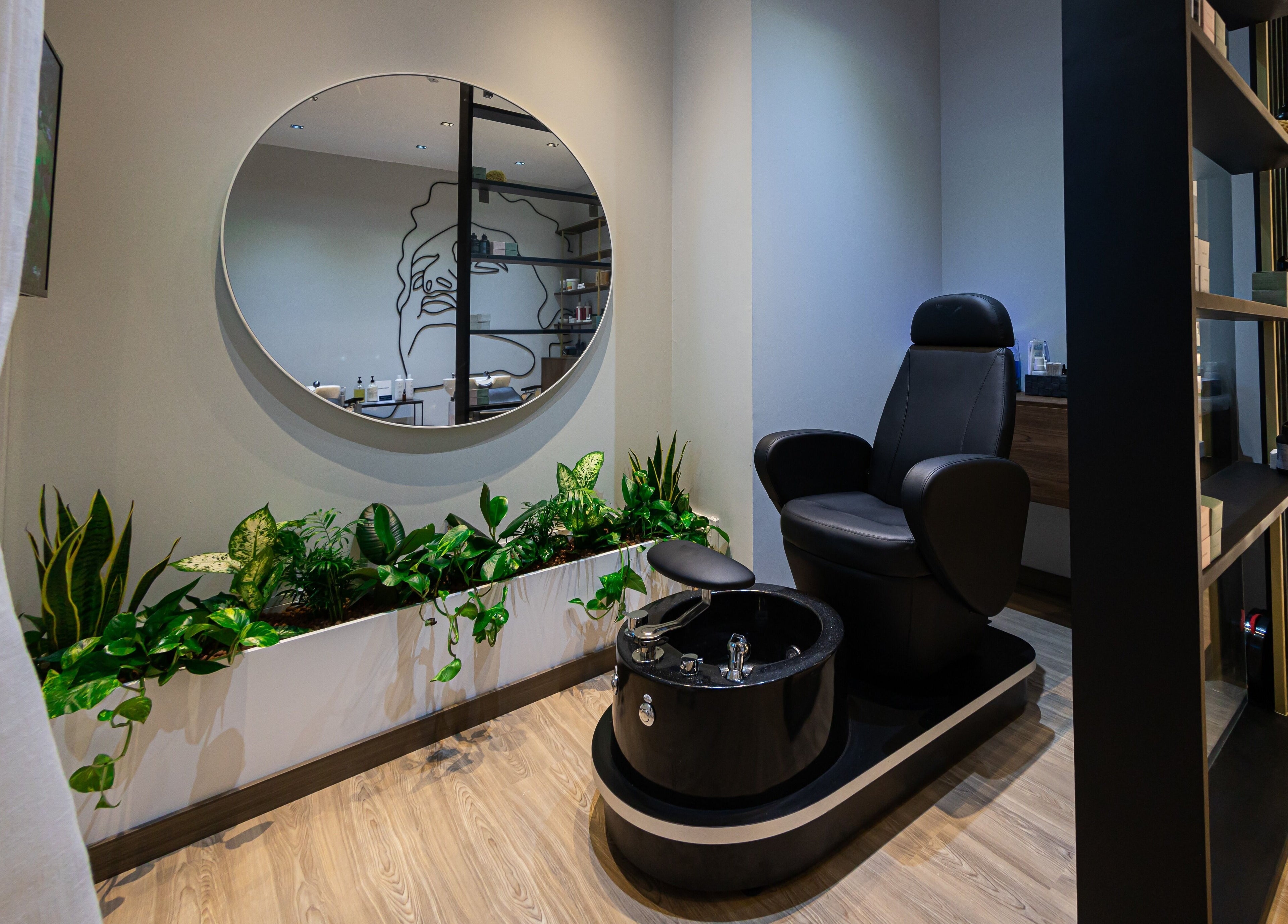 Pedicure chair and greenery at Antibes Salon Seef, Manama, BH, offering luxury beauty treatments.