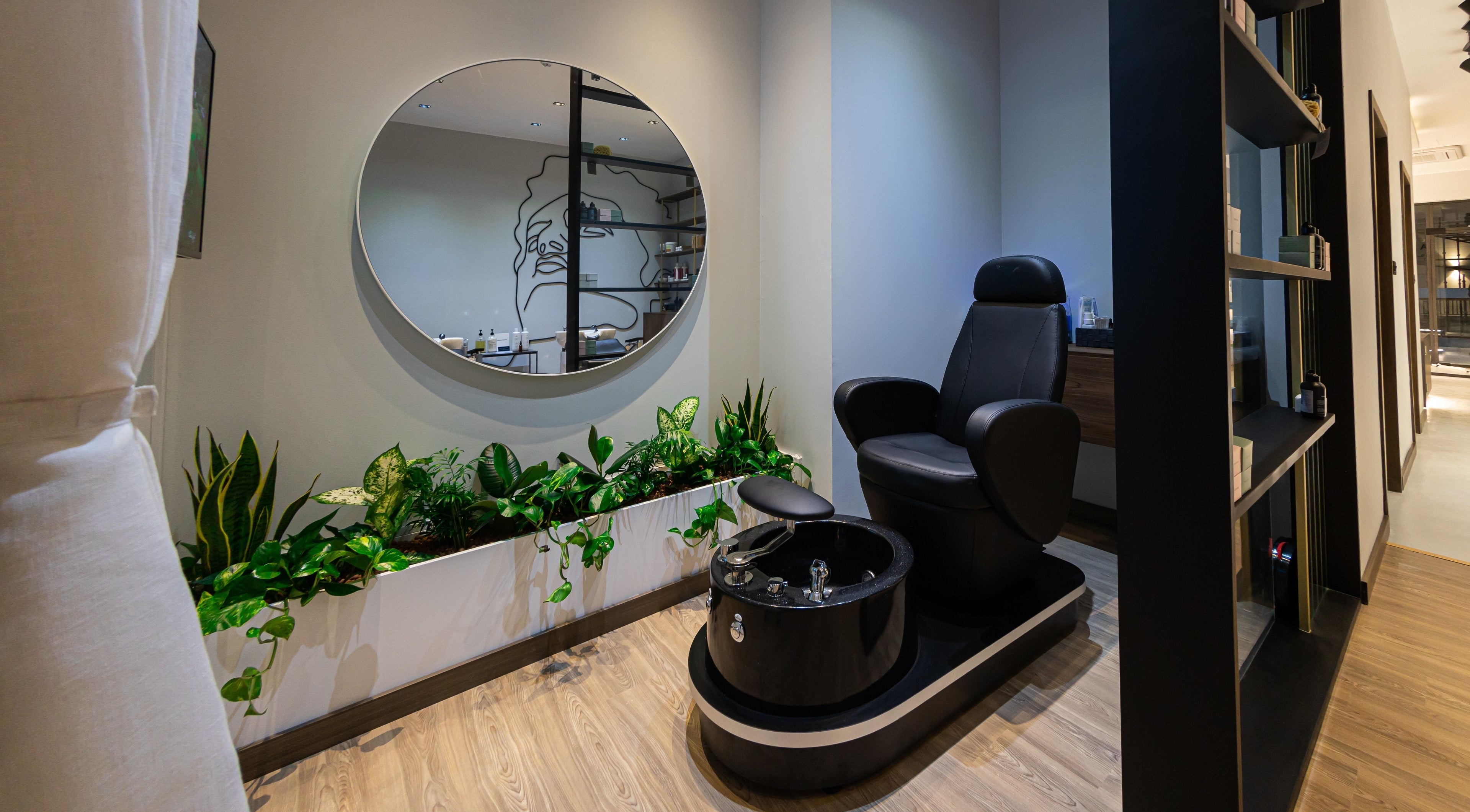 Pedicure chair and greenery at Antibes Salon Seef, Manama, BH, offering luxury beauty treatments.