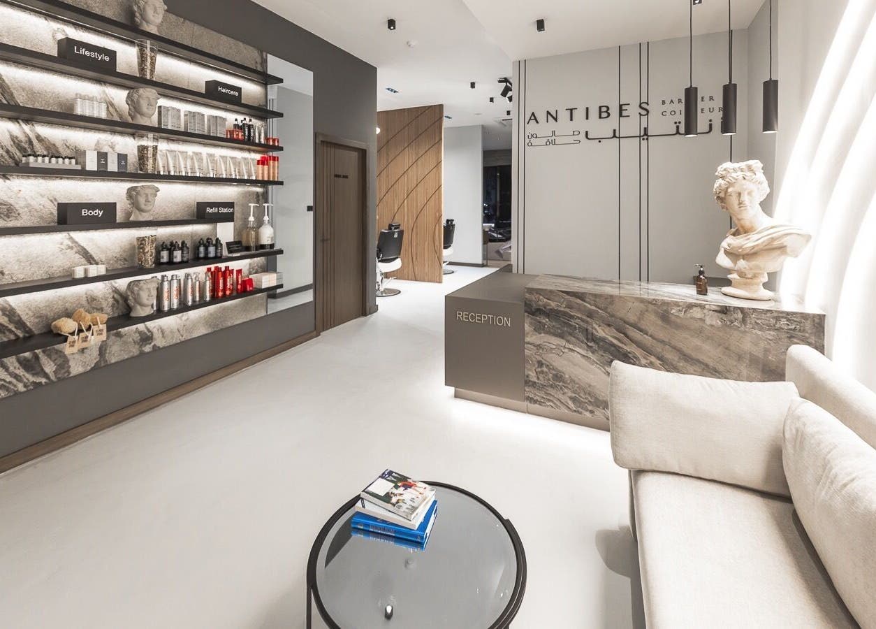 Reception area of Antibes Salon Seef in Manama, BH featuring chic decor and product displays.