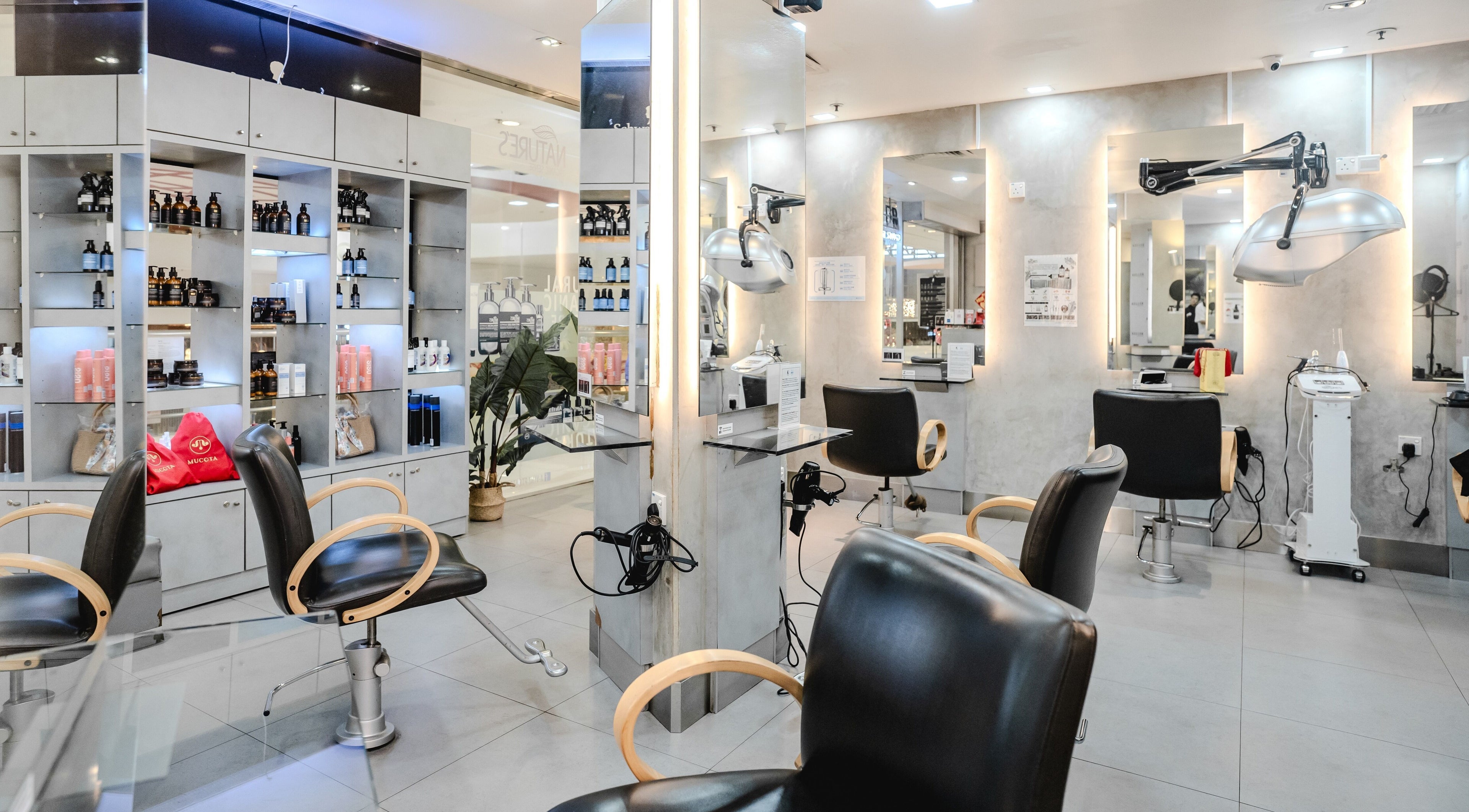 Modern interior of Keller Hair Studio in Singapore, Singapore, SG featuring stylish salon chairs and products.
