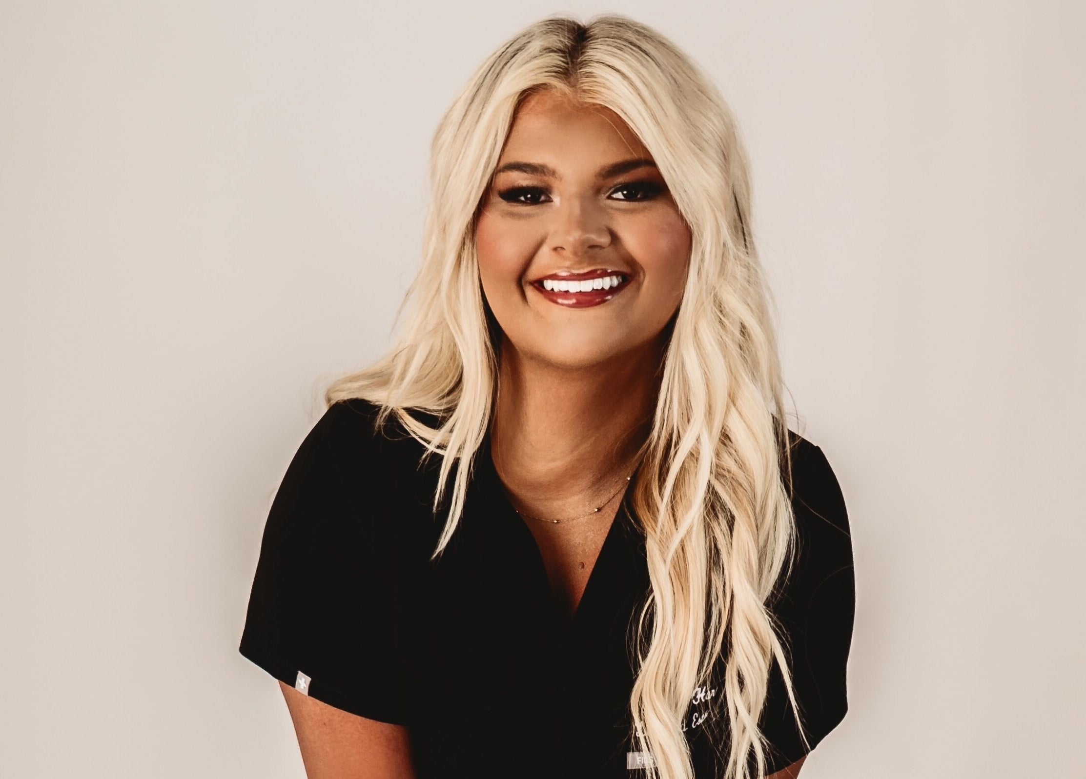 Smiling woman at Belle Beauty Bar, Shawneetown, Illinois, US, showcasing professional hairstyle.