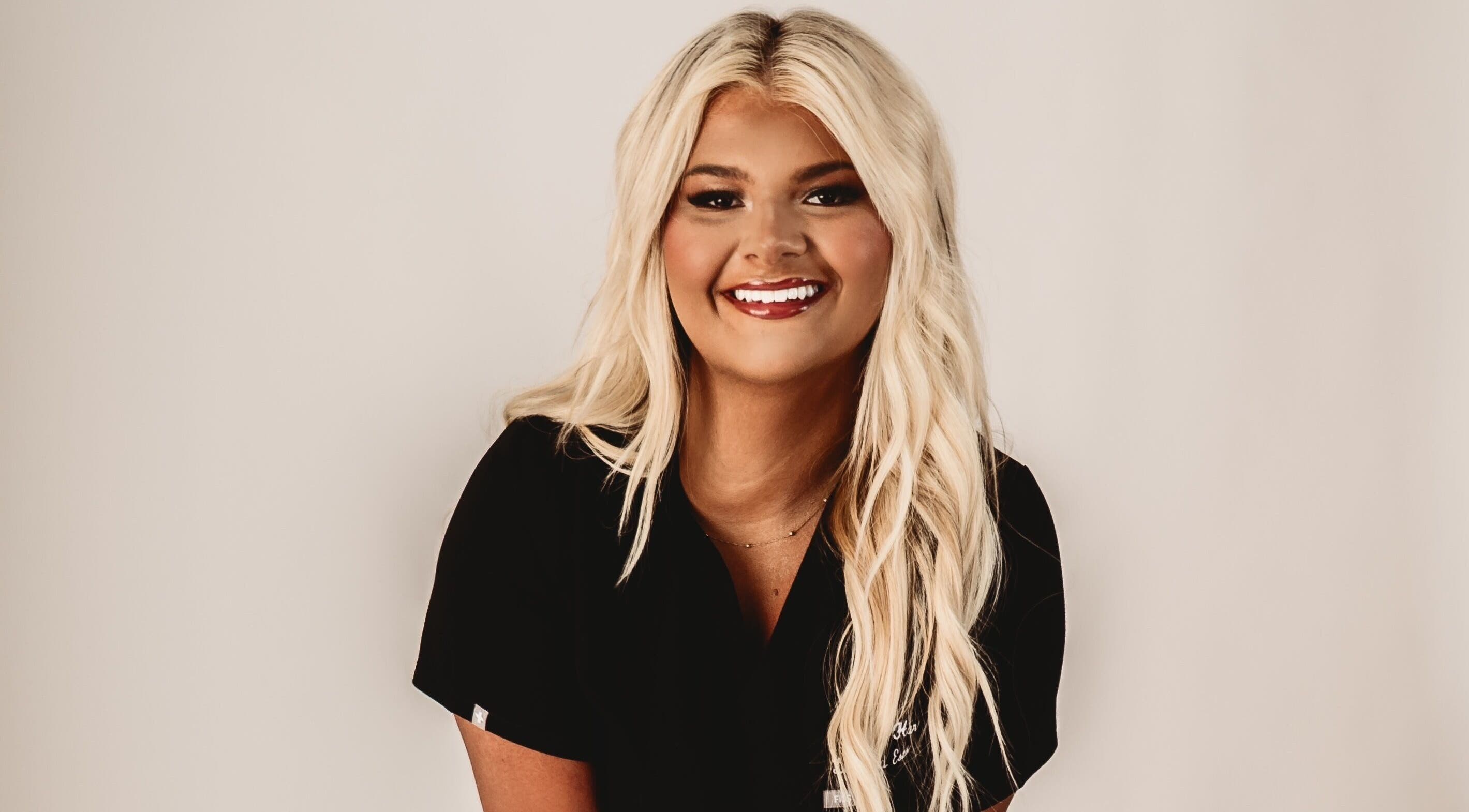 Smiling woman at Belle Beauty Bar, Shawneetown, Illinois, US, showcasing professional hairstyle.