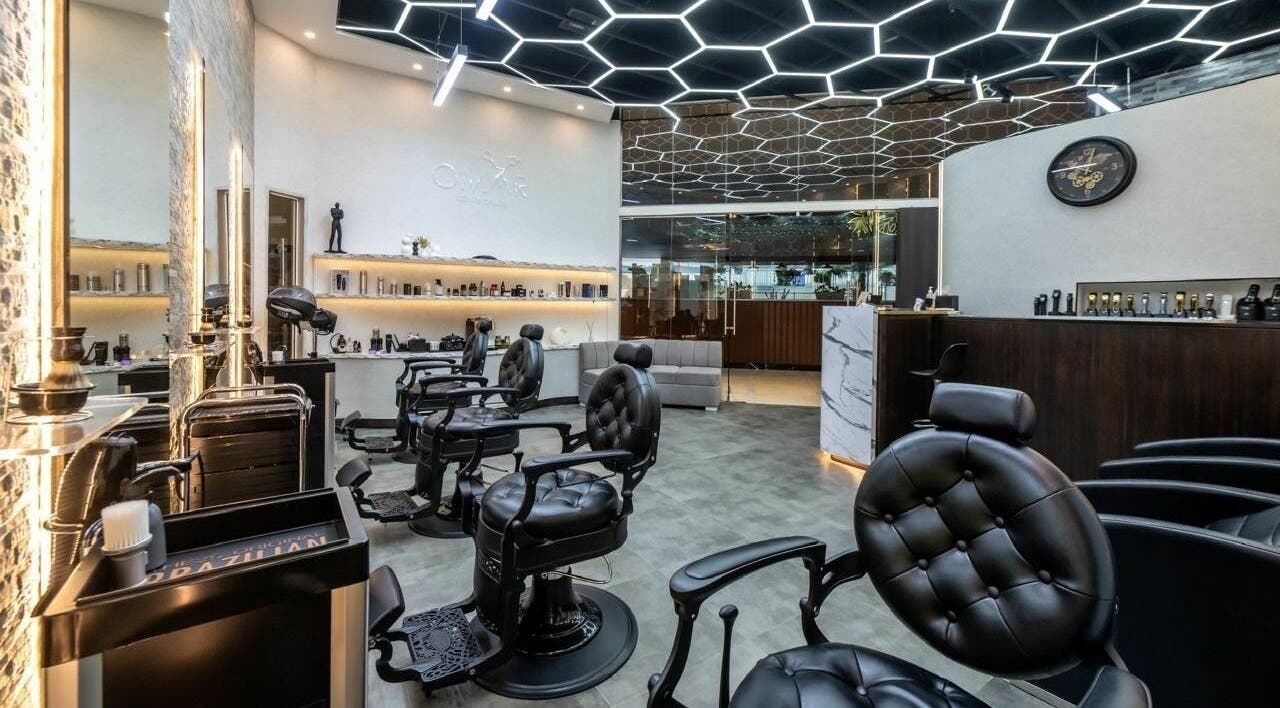 Luxurious interior of Omar Gents Salon in Dubai, Dubai, AE featuring sleek barber chairs and modern design.