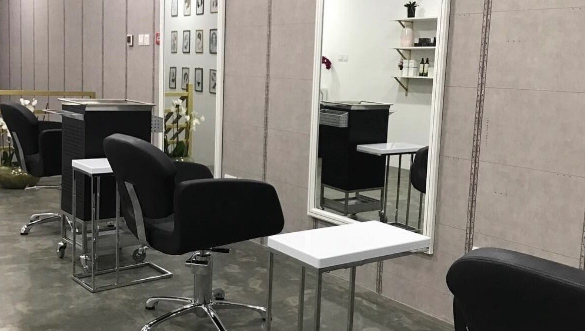 Modern interior of Color Cravings Beauty Salon in Bu Quwah, Northern Governorate, BH, showcasing sleek styling stations.