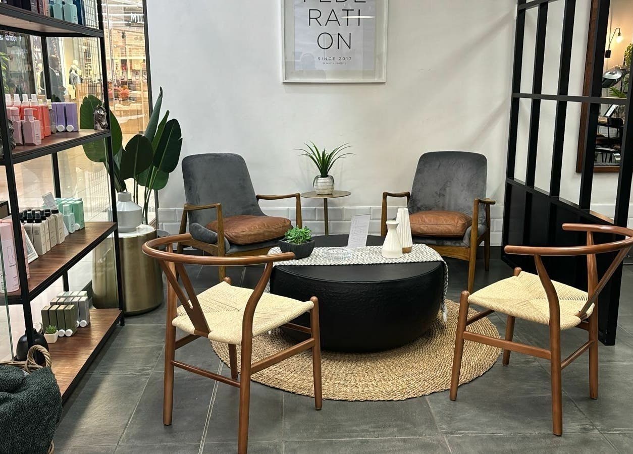 Modern seating area at The Federation Kyalami, Midrand, Gauteng, ZA, featuring stylish chairs and decor.
