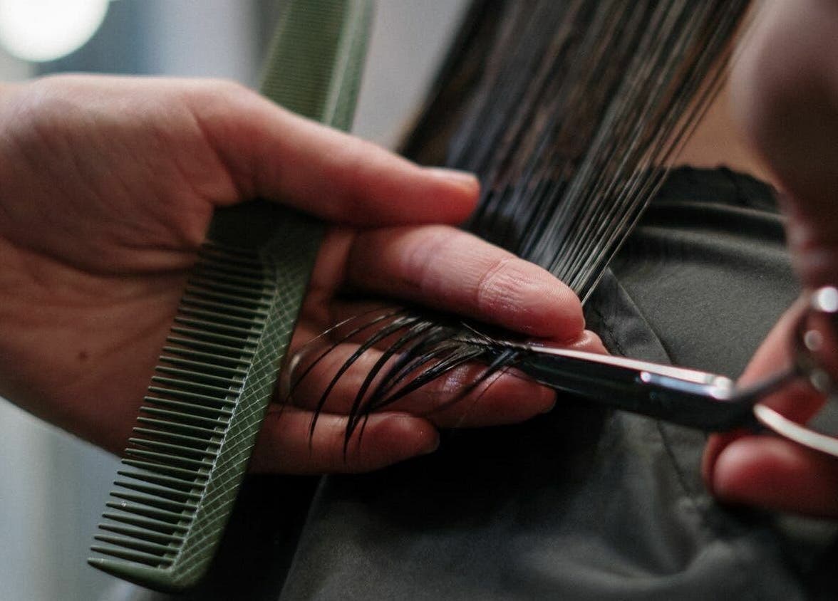 Close-up of a haircut at The Federation Kyalami, Midrand, Gauteng, ZA, showcasing precision and care.