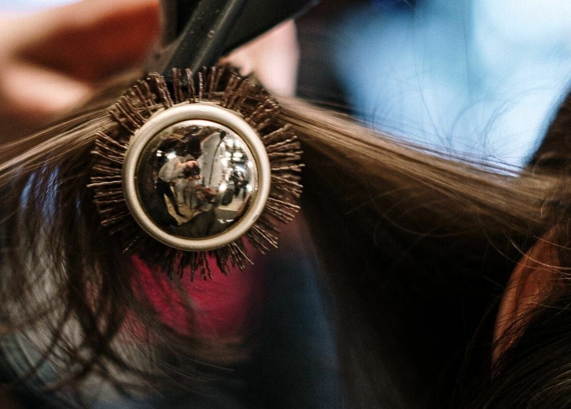Close-up of hairstyling at The Federation Kyalami, Midrand, Gauteng, ZA with a brush in use.