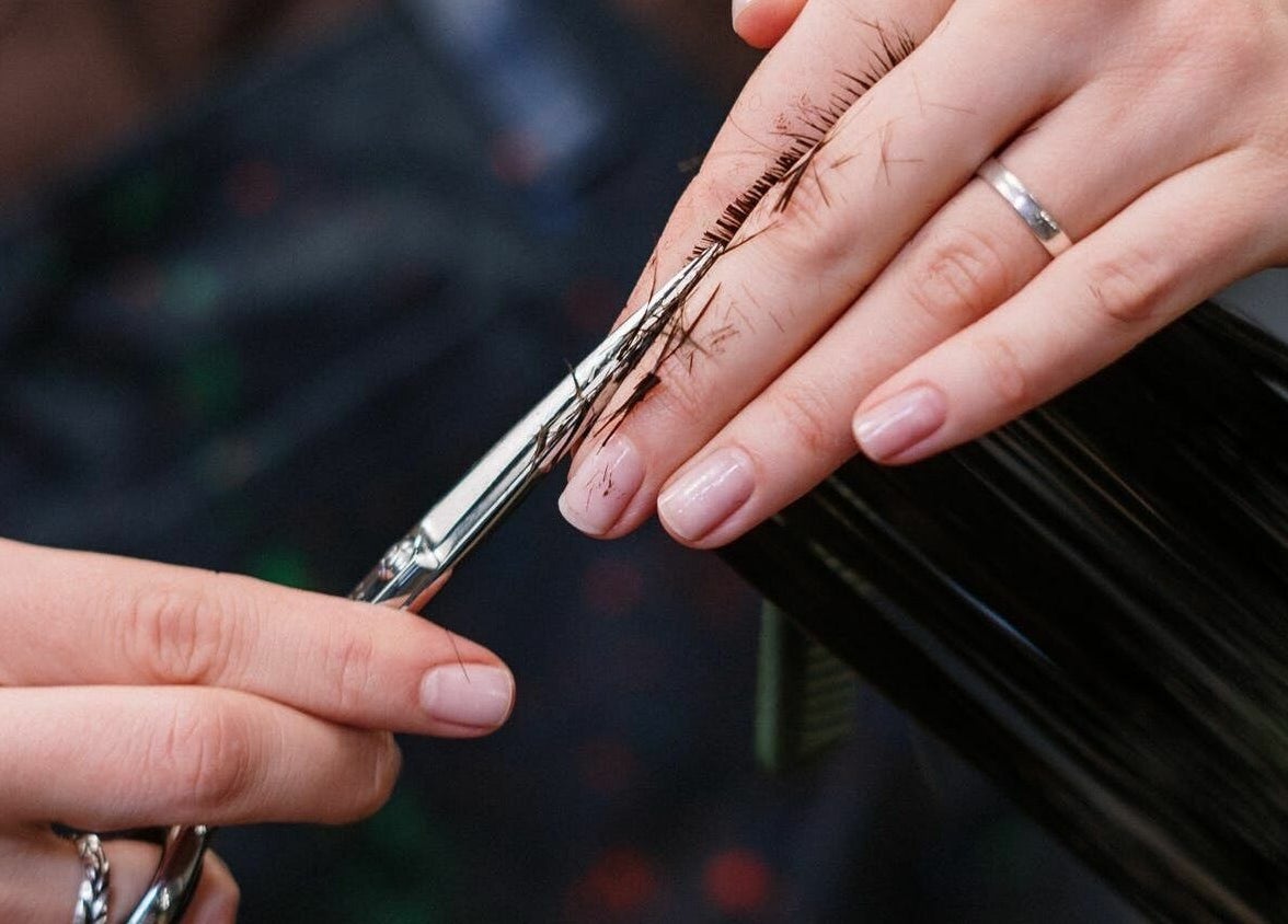 A stylist trims hair with precision at The Federation Kyalami, Midrand, Gauteng, ZA.