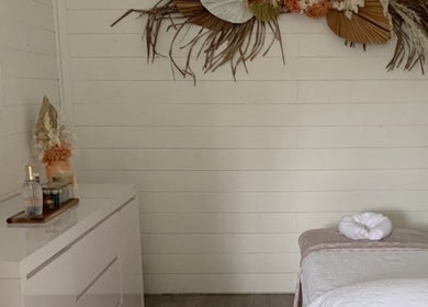 Serene massage room at Phoenix Remedial Massage, Belford, New South Wales, AU, with elegant decor and treatment bed.