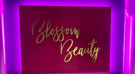 Vibrant Blossom Beauty sign in Abbeyleix, County Laois, IE, illuminated with neon purple lights.