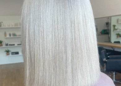 Sleek blonde hairstyle showcased at Malia Hair and Beauty Boutique, Hastings, Victoria, AU salon interior.