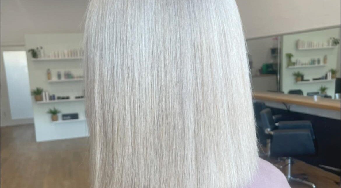 Sleek blonde hairstyle showcased at Malia Hair and Beauty Boutique, Hastings, Victoria, AU salon interior.