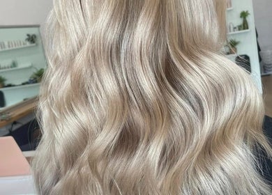 Stylish blonde waves at Malia Hair and Beauty Boutique in Hastings, Victoria, AU.