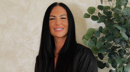 A smiling professional from Xtreme Beauty (Mobile Therapist), Ponteland, England, GB, with lush greenery background.