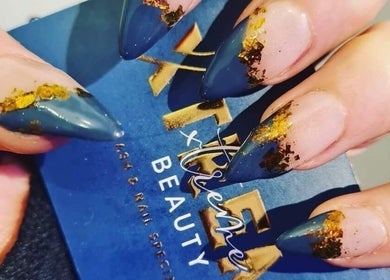 Elegant blue and gold nail art by Xtreme Beauty (Mobile Therapist) in Ponteland, England, GB.