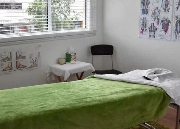 Cozy massage room at The Massage Clinic, Taupo, Waikato, NZ with a green-covered massage table.