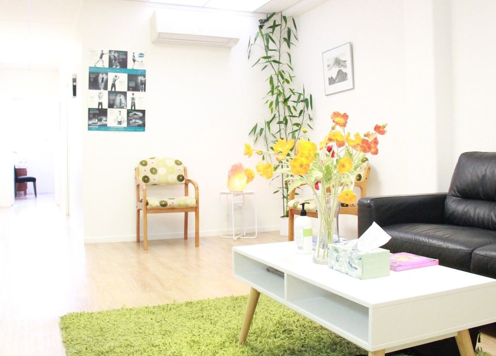 The Massage Clinic lounge in Taupo, Waikato, NZ features cozy seating and vibrant decor for relaxation.