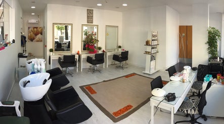 Interior elegante do Atena Hair Style & Spa em Porto, PT, com estações de beleza modernas e decorativas.