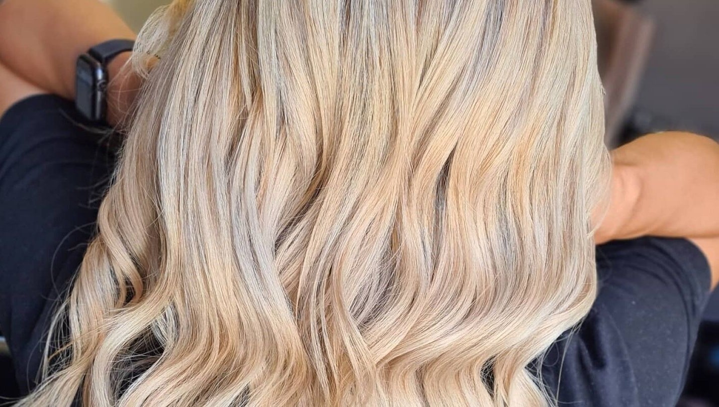Blonde wavy hair styled at Luxe & Co ByAshHair in Cardiff, Wales, GB. Elegant salon hair transformation.