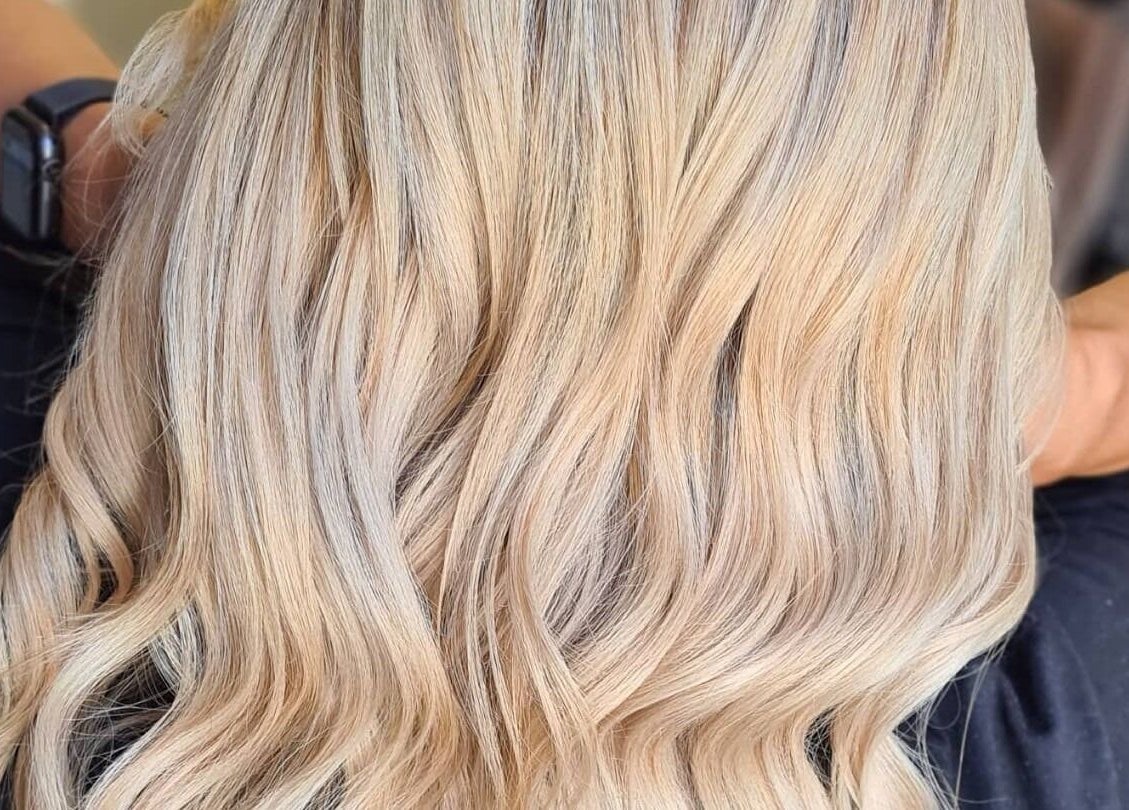 Blonde wavy hair styled at Luxe & Co ByAshHair in Cardiff, Wales, GB. Elegant salon hair transformation.