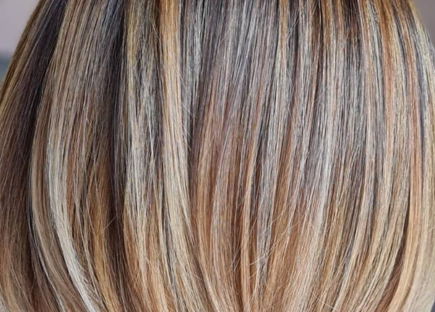 Smooth, highlighted hair showcased at Luxe & Co ByAshHair, Cardiff, Wales, GB for a sleek look.