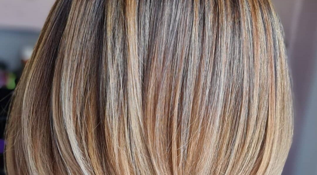 Smooth, highlighted hair showcased at Luxe & Co ByAshHair, Cardiff, Wales, GB for a sleek look.