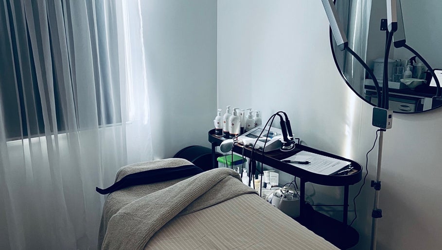 Serene treatment room at The Beauty Loft, Waihi Beach, Bay Of Plenty, NZ with a spa bed and tools.