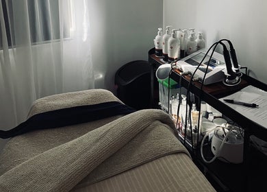 Relaxing treatment room at The Beauty Loft, Waihi Beach, Bay Of Plenty, NZ, featuring modern equipment and cozy ambiance.