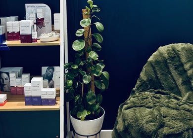 Cozy corner at The Beauty Loft, Waihi Beach, Bay Of Plenty, NZ with skincare products and lush greenery.