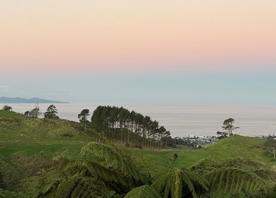 Scenic view of Waihi Beach's lush hills and serene ocean, near The Beauty Loft, Bay Of Plenty, NZ.