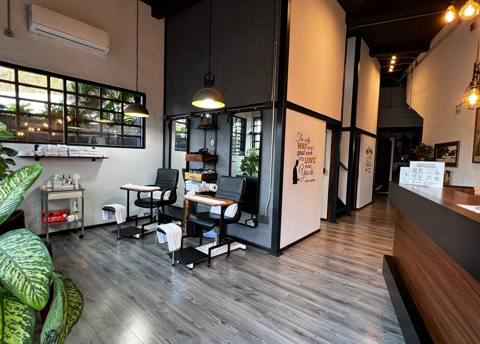 Modern interior of Waxing4Men in Puerto Vallarta, Jalisco, MX showcasing sleek chairs and plants.