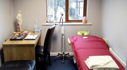 AcuRodos - Acupuncture & Chinese Medicine Clinic therapy room in Clonee, Leinster, IE with massage table and desk.